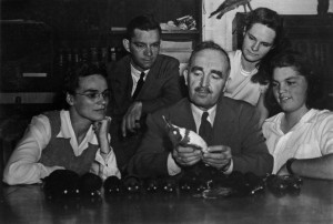 Brina Kessel (rightmost) looks on as Arthur Allen examines a specimen.